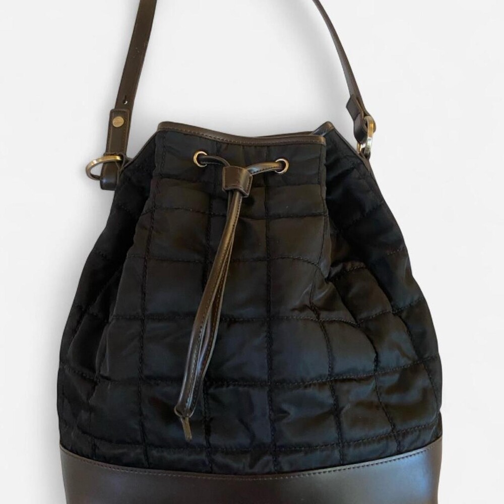 Jones New York black quilted bucket bag with faux leather trim. Functional and s